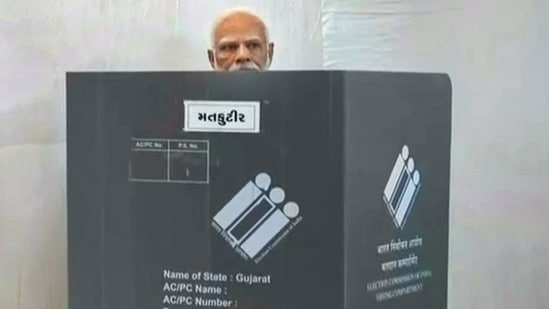 PM Modi arrived at the polling station at Nishan High School in Ranip locality of Ahmedabad at around 9.30 am and stood in a queue for a while to cast his vote.(PTI)