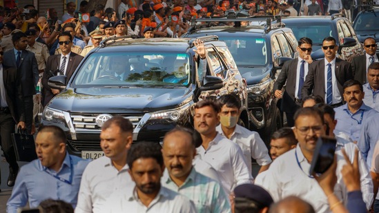 Prime Minister Narendra Modi waves at supporters as he leaves after casting his vote at a polling booth at Ranip area in Ahmedabad.(PTI)
