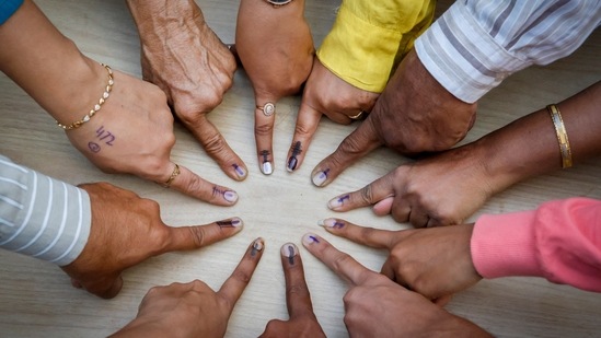 Ahmedabad: Voters pose for a photo showing their fingers marked with indelible ink after casting their votes. Ahmedabad: Voters pose for a photo showing their fingers marked with indelible ink after casting their votes.
