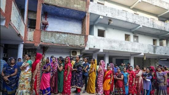 People stand in queue to cast their votes during the second phase of Gujarat state legislature elections in Ahmedabad, India, Monday, Dec. 5, 2022. The local elections in Prime Minister Narendra Modi's home state is seen as a barometer of his ruling Bharatiya Janata Party's popularity ahead of a general election in 2024. (AP Photo/Ajit Solanki) (AP)