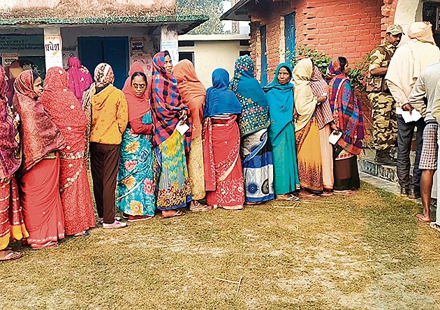 People wait in a queue to cast their vote during the Kurhani bypoll in Bihar’s Muzaffarpur on Monday. (ANI)