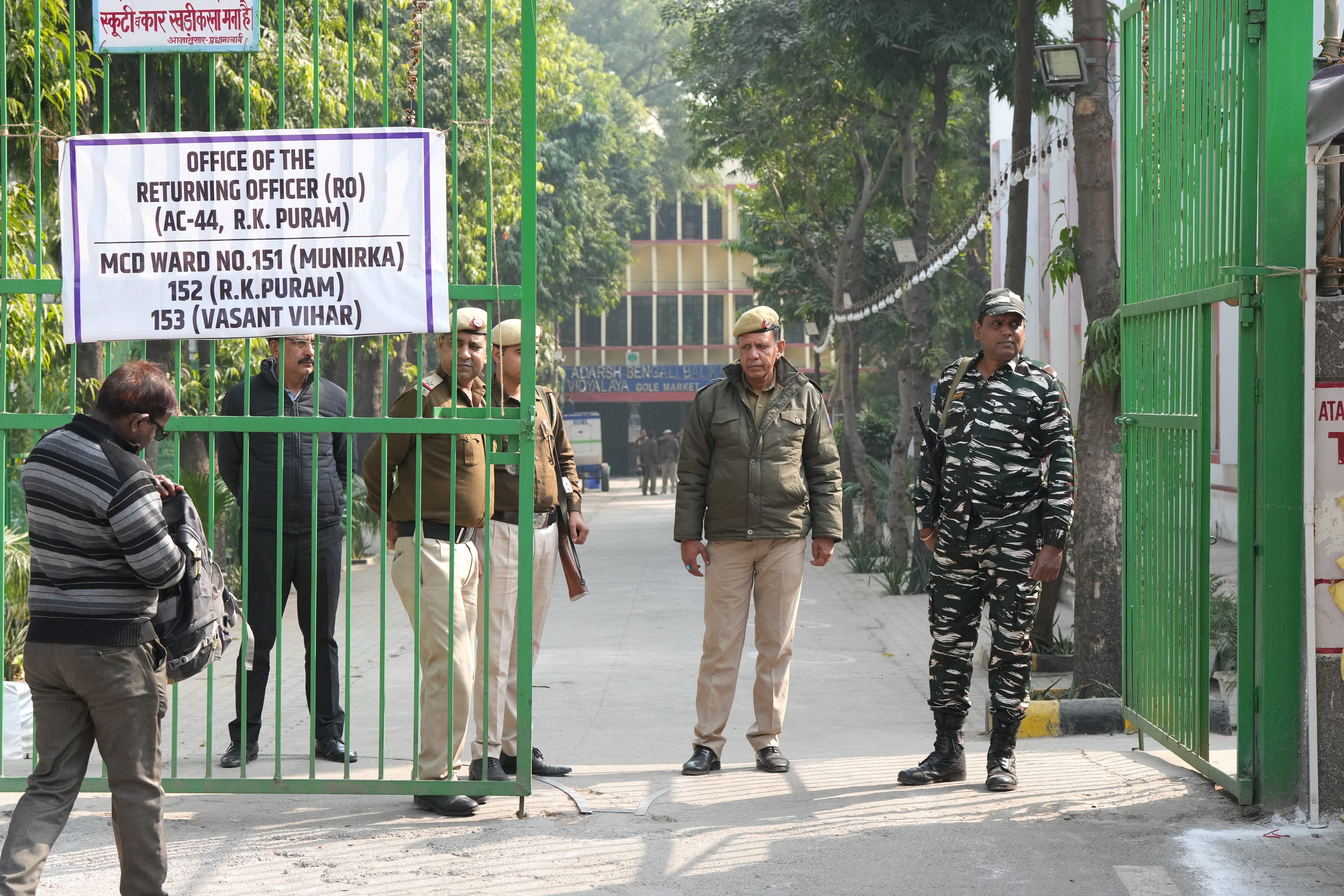Security personnel stand guard outside a strongroom where ballot boxes are kept, after the Municipal Corporation of Delhi (MCD) elections, at Gole Market in New Delhi on Monday. (PTI) Security personnel stand guard outside a strongroom where ballot boxes are kept, after the Municipal Corporation of Delhi (MCD) elections, at Gole Market in New Delhi on Monday. (PTI)