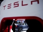 A Tesla electric vehicle is seen through a charging point.