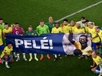 Brazil's players hold a banner dedicated to banner Brazilian football legend Pele at the end of the Qatar 2022 World Cup round of 16 football match between Brazil and South Korea Brazil's players hold a banner dedicated to banner Brazilian football legend Pele at the end of the Qatar 2022 World Cup round of 16 football match between Brazil and South Korea