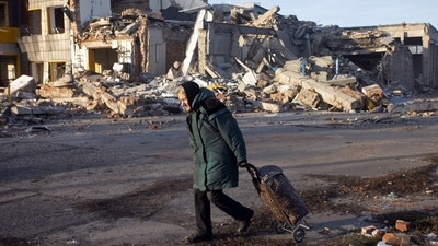 An elderly woman pulls a trolley bag past a destroyed building in Bakhmut, Donetsk region, on December 4, amid Russia's invasion of Ukraine. According to the Donetsk region military administration, Bakhmut, besieged by Russian forces for months, has witnessed some of the most ferocious fighting of the war. (Yevhen Titov / AFP) An elderly woman pulls a trolley bag past a destroyed building in Bakhmut, Donetsk region, on December 4, amid Russia's invasion of Ukraine. According to the Donetsk region military administration, Bakhmut, besieged by Russian forces for months, has witnessed some of the most ferocious fighting of the war. (Yevhen Titov / AFP)