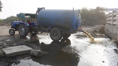 A privately-owned tanker releases waste collected from septic tanks in the city in an open area near Gurugram- Dwarka Expressway. (HT Archive) A privately-owned tanker releases waste collected from septic tanks in the city in an open area near Gurugram- Dwarka Expressway. (HT Archive)