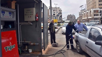 A worker fills a pickup at a gas station, in Homs, Syria. (AP) A worker fills a pickup at a gas station, in Homs, Syria. (AP)