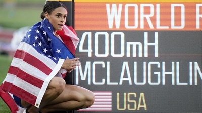 Gold medalist Sydney McLaughlin, of the United States, poses by a sign after winning the final of the women's 400-meter hurdles (AP) Gold medalist Sydney McLaughlin, of the United States, poses by a sign after winning the final of the women's 400-meter hurdles (AP)