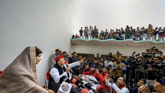 Samajwadi Party President Akhilesh Yadav with his wife and party candidate Dimple Yadav address a press conference after casting vote for the Mainpuri Lok Sabha seat by-elections, at Saifai in Etawah district. (PTI)
