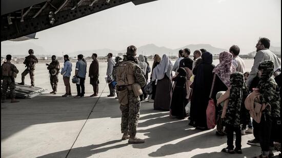 Evacuees wait to board a Boeing C-17 Globemaster III during an evacuation at Hamid Karzai International Airport in Kabul, Afghanistan on August 30, 2021. (via REUTERS)