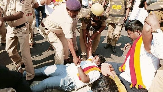 Police personnel detain Karnataka Rakshana Vedike supporters during a protest over the Maharashtra-Karnataka border dispute in Belagavi on Tuesday. (ANI)