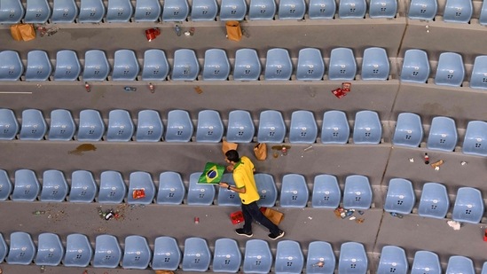 FIFA World Cup: A lone Brazil fan walks through the empty rows of seats after the Qatar 2022 World Cup round of 16 football match.(AFP) FIFA World Cup: A lone Brazil fan walks through the empty rows of seats after the Qatar 2022 World Cup round of 16 football match.(AFP)