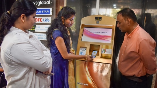 Hyderabad: A woman withdraws gold coins from Gold ATM, Begumpet, in Hyderabad. (PTI) Hyderabad: A woman withdraws gold coins from Gold ATM, Begumpet, in Hyderabad. (PTI)
