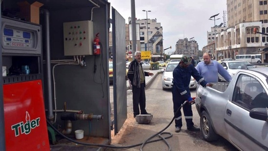 A worker fills a pickup at a gas station, in Homs, Syria. (AP) A worker fills a pickup at a gas station, in Homs, Syria. (AP)