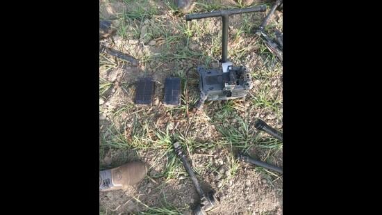 The damaged drone that was recovered from a field near Kalia village in Bhikhiwind sub division of Tarn Taran district on Tuesday morning after it was shot down on Monday night. (HT Photo)