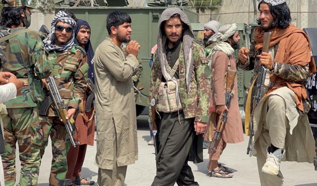 Taliban forces patrol a runway a day after US troops withdrew from Hamid Karzai International Airport in Kabul, Afghanistan on August 31, 2021. (REUTERS) Taliban forces patrol a runway a day after US troops withdrew from Hamid Karzai International Airport in Kabul, Afghanistan on August 31, 2021. (REUTERS)