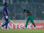 Indian captain Rohit Sharma, left, walks back as Bangladesh' Mustafizur Rahman right celebrates winning the second one day international cricket match between Bangladesh and India in Dhaka.