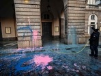 An employee hoses the facade of the La Scala theater in Milan on December 7 after environmental activists from the "Last Generation" (Ultima Generazione) group smeared it with paint during a group's action aimed at raising awareness about climate change on the day of La Scala's new season's opening.