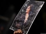 Jina Mahsa Amini, whose portrait is held up here, has become the face of Iran's protests. 