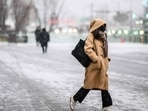 South Korea: A woman walks in Gwanghwamun Plaza as it snows in Seoul. South Korea: A woman walks in Gwanghwamun Plaza as it snows in Seoul.