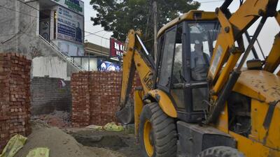 A portion of illegal being razed by the MC team in Model Town extension area, Ludhiana. (Harvinder Singh/HT)
