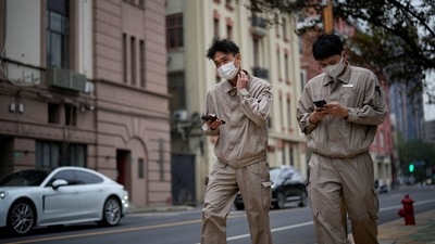 Covid In China: Two men wearing face masks walk on a street, as coronavirus disease (COVID-19) outbreaks continue in Shanghai, China. (Reuters)