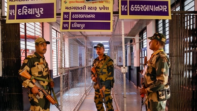 Ahmedabad: Border Security force (BSF) personnel stand guard at a strong room ahead of counting for the Gujarat Assembly elections, in Ahmedabad on Tuesday. (PTI) Ahmedabad: Border Security force (BSF) personnel stand guard at a strong room ahead of counting for the Gujarat Assembly elections, in Ahmedabad on Tuesday. (PTI)