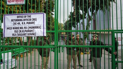New Delhi: Security personnel stand guard outside a strong room, where EVMs are kept, ahead of the counting for the Municipal Corporation of Delhi (MCD) elections result, at Gole Market in New Delhi. (PTI) New Delhi: Security personnel stand guard outside a strong room, where EVMs are kept, ahead of the counting for the Municipal Corporation of Delhi (MCD) elections result, at Gole Market in New Delhi. (PTI)