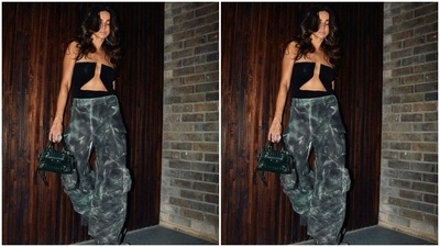 Shibani styled the ensemble by layering an oversized black jacket on her shoulders and carrying a green patterned leather top handle bag. The blazer features notch lapel collars, full-length sleeves, side pockets, and contrast stitching. (Instagram) Shibani styled the ensemble by layering an oversized black jacket on her shoulders and carrying a green patterned leather top handle bag. The blazer features notch lapel collars, full-length sleeves, side pockets, and contrast stitching. (Instagram)