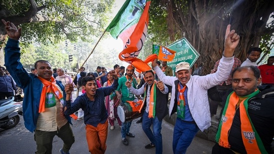 BJP supporters celebrates outside a counting station for MCD Elections 2022 at Gole Market in New Delhi, India, December 7. (Photo by Sanchit Khanna/ Hindustan Times)(Hindustan Times)