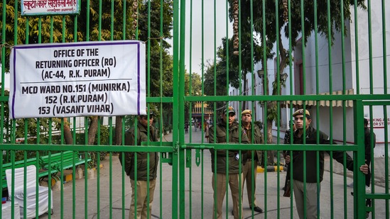 New Delhi: Security personnel stand guard outside a strong room, where EVMs are kept, ahead of the counting for the Municipal Corporation of Delhi (MCD) elections result, at Gole Market in New Delhi. (PTI)