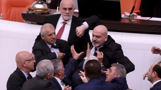Turkey Parliament: Zafer Isik, a lawmaker punches Huseyin Ors, a lawmaker from the opposition.(AP) Turkey Parliament: Zafer Isik, a lawmaker punches Huseyin Ors, a lawmaker from the opposition.(AP)