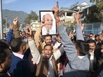 Supporters hold a picture of former minister late Sukh Ram as they celebrate the victory of his son and BJP candidate Anil Sharma in the Himachal Pradesh assembly election in Mandi on Thursday. (ANI Photo) Supporters hold a picture of former minister late Sukh Ram as they celebrate the victory of his son and BJP candidate Anil Sharma in the Himachal Pradesh assembly election in Mandi on Thursday. (ANI Photo)