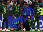 Pakistan's Shaheen Afridi, second right, is attended to after falling while catching out England's Harry Brook during the final of the T20 World Cup Cricket tournament at the Melbourne Cricket Ground in Melbourne, Australia, Sunday, Nov. 13, 2022. AP/PTI(AP11_13_2022_000134B)(AP) Pakistan's Shaheen Afridi, second right, is attended to after falling while catching out England's Harry Brook during the final of the T20 World Cup Cricket tournament at the Melbourne Cricket Ground in Melbourne, Australia, Sunday, Nov. 13, 2022. AP/PTI(AP11_13_2022_000134B)(AP)