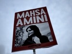 Iran Anti-Hijab Protests: A woman holds a placard with a picture of Iranian woman Mahsa Amini during a protest against her death.(AP) Iran Anti-Hijab Protests: A woman holds a placard with a picture of Iranian woman Mahsa Amini during a protest against her death.(AP)