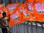 A Bharatiya Janta Party worker erecting BJP flags.