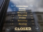 A closed sign hangs in the door of a temporarily closed down retail outlet in U.K. A closed sign hangs in the door of a temporarily closed down retail outlet in U.K.