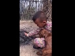 The kid is warming his hand in the freezing weather. 