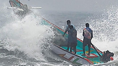 Fishermen manoeuvre their boat through waves at Pattinapakkam beach in Chennai ahead of Cyclone Mandous forecasted landfall in north Tamil Nadu-south Andhra Pradesh coasts. (AFP) Fishermen manoeuvre their boat through waves at Pattinapakkam beach in Chennai ahead of Cyclone Mandous forecasted landfall in north Tamil Nadu-south Andhra Pradesh coasts. (AFP)