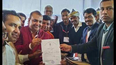 BJP candidate Akash Saxena (in red) receives the ‘Certificate of Election’ after winning the Rampur Assembly by-elections, in Rampur, Thursday. (PTI Photo) BJP candidate Akash Saxena (in red) receives the ‘Certificate of Election’ after winning the Rampur Assembly by-elections, in Rampur, Thursday. (PTI Photo)