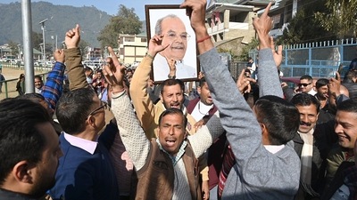 Supporters hold a picture of former minister late Sukh Ram as they celebrate the victory of his son and BJP candidate Anil Sharma in the Himachal Pradesh assembly election in Mandi on Thursday. (ANI Photo)