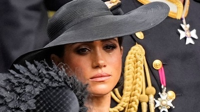 Meghan Markle: Meghan, Duchess of Sussex watches as the coffin of Queen Elizabeth II is placed into the hearse. (AP) Meghan Markle: Meghan, Duchess of Sussex watches as the coffin of Queen Elizabeth II is placed into the hearse. (AP)