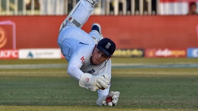England's wicketkeeper Ollie Pope dives to take a catch (REUTERS)