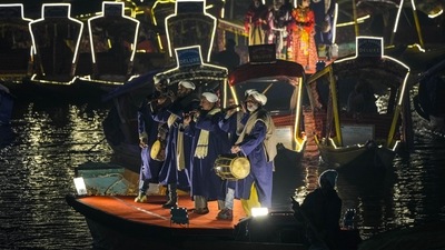 Kashmiri folk artists perform during a laser show and and live concert organised to boost winter tourism at the Dal Lake in Srinagar. (AP) Kashmiri folk artists perform during a laser show and and live concert organised to boost winter tourism at the Dal Lake in Srinagar. (AP)