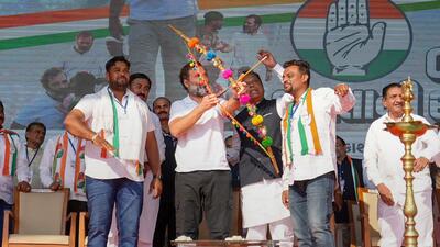 Congress leader Rahul Gandhi draws a bow and an arrow during a public rally in Surat, Gujarat. (PTI) Congress leader Rahul Gandhi draws a bow and an arrow during a public rally in Surat, Gujarat. (PTI)