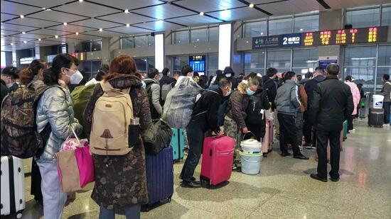 Passengers wait for their trains at Yichang East Railway Station in China’s central Hubei province on Thursday, following the easing of Covid-19 restrictions in the city. (AFP)