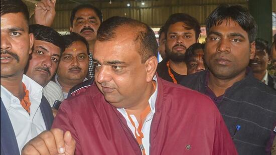BJP candidate Akash Saxena celebrates after winning, in Rampur. (PTI)