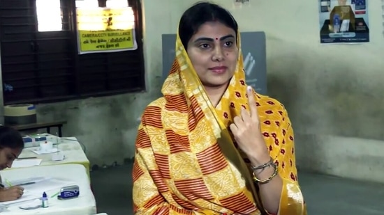  Rajkot, Dec 01 (ANI): Bharatiya Janata Party (BJP) candidate from Jamnagar North Rivaba Jadeja shows her ink-marked finger after casting her vote for the first phase of Gujarat Assembly elections, in Rajkot on Thursday. (ANO Photo)(ANI)