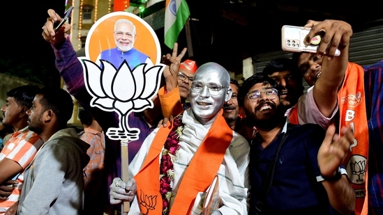 Supporters of BJP celebrate during a felicitation programme organised for Gujarat CM Bhupendrabhai Patel (not pictured) in Ahmedabad on Thursday.(AFP)