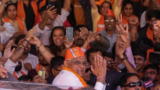 Supporters of the Bharatiya Janata Party (BJP) celebrate as the party recorded a historic win in Gujarat, winning 156 seats in Gujarat Assembly polls. Prime Minister Narendra Modi’s party is all set to keep its 27-year-old control of his home Gujarat state in a record state legislature win.(AP)